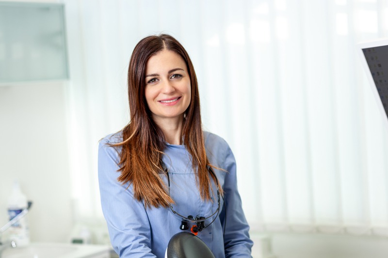 Female dentist comforting depressed male patient in pain